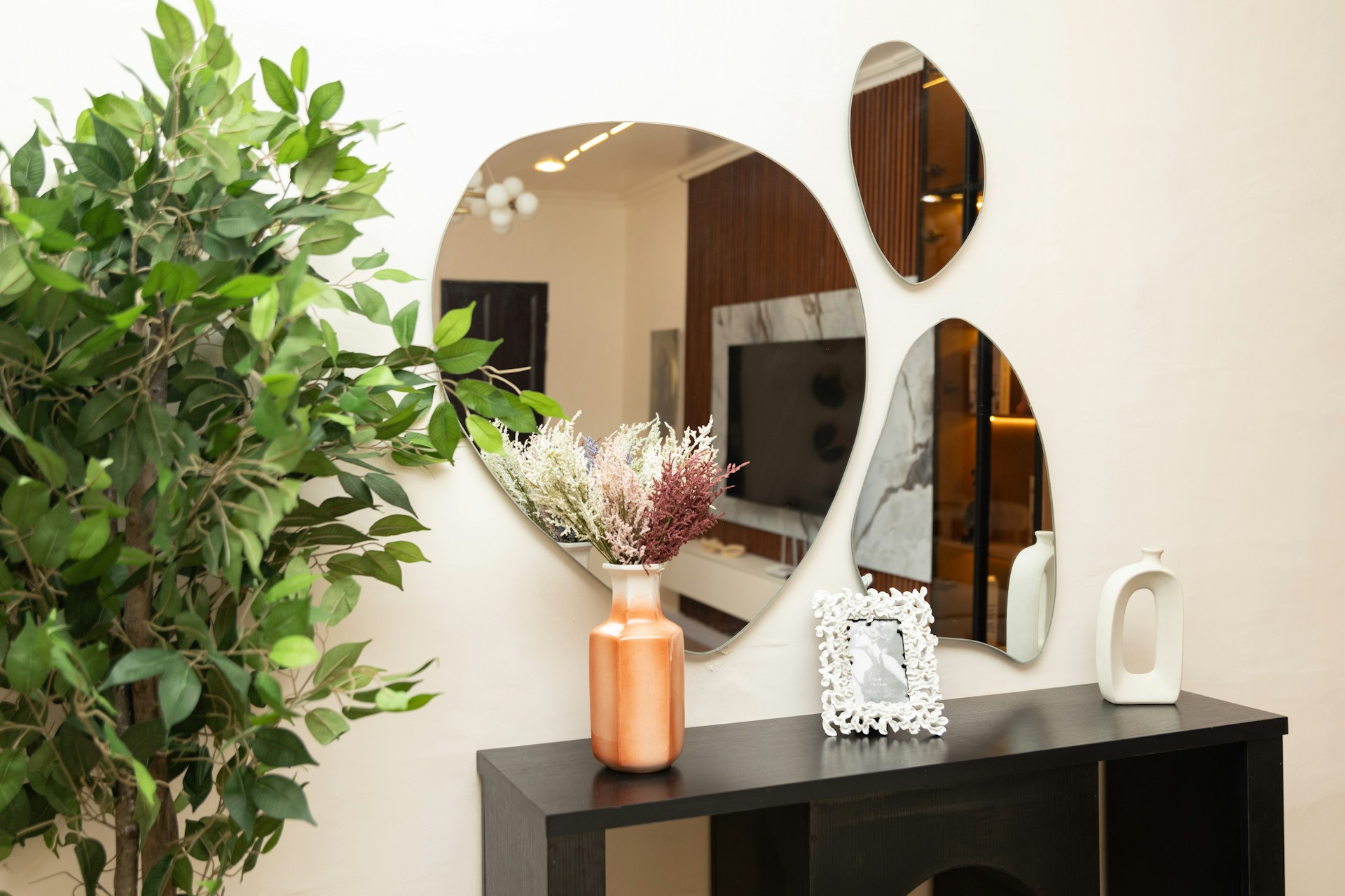 Tall artificial plant styled in a living room entryway for home decor