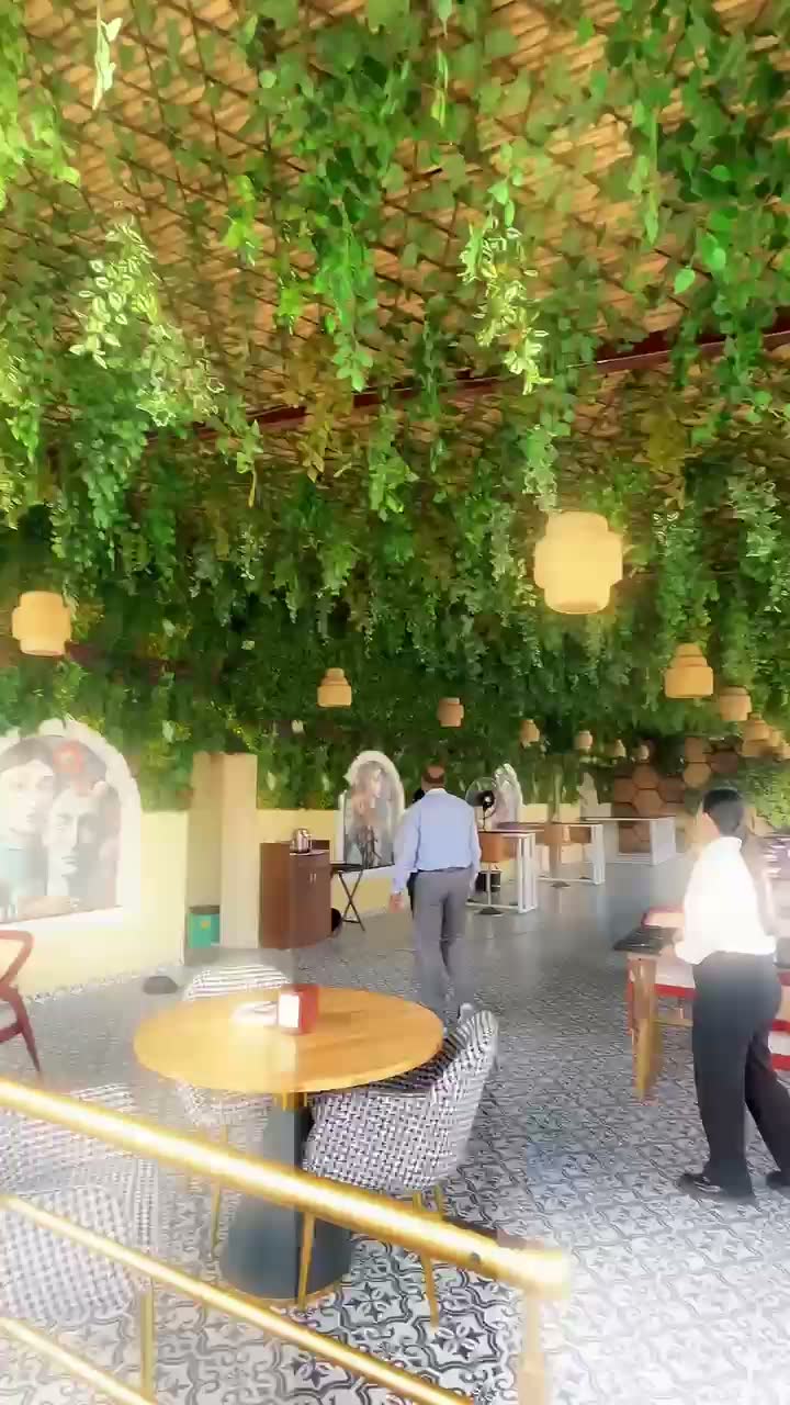 Hanging green canopy installation at a restaurant